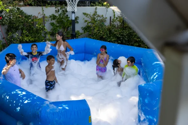 Kids playing in a foam pit add-on during a foam party