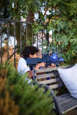 Kid shooting a laser tag gun during a Los Angeles party