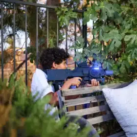 Kid shooting a laser tag gun during a Los Angeles party